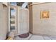 Close-up of an elegant tan front door with security screen, decorative accents, and desert landscaping at 4903 S Desert Willow Dr, Gold Canyon, AZ 85118