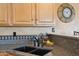 Kitchen sink area with dark granite counters, a black faucet, and a decorative tile backsplash at 4903 S Desert Willow Dr, Gold Canyon, AZ 85118