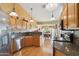 Spacious kitchen boasts wooden cabinets, granite countertops, and modern stainless-steel appliances at 4903 S Desert Willow Dr, Gold Canyon, AZ 85118