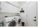 Well-equipped laundry room with modern washer and dryer and overhead storage at 4903 S Desert Willow Dr, Gold Canyon, AZ 85118