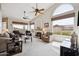 Bright living room featuring high ceilings, a cozy fireplace, and ample natural light from large windows at 4903 S Desert Willow Dr, Gold Canyon, AZ 85118
