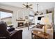 Inviting living room with a fireplace, comfortable seating, and views of the scenic desert landscape at 4903 S Desert Willow Dr, Gold Canyon, AZ 85118