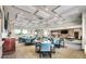 Large community meeting room with multiple tables and chairs, and large windows for natural light at 4903 S Desert Willow Dr, Gold Canyon, AZ 85118