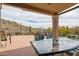 Covered patio with desert views, built-in BBQ, and outdoor dining table with chairs at 4903 S Desert Willow Dr, Gold Canyon, AZ 85118