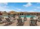 Relaxing community pool with comfortable lounge chairs, umbrellas, and inviting, crystal-clear water at 4903 S Desert Willow Dr, Gold Canyon, AZ 85118