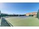 Exterior shot of well-maintained tennis court and basketball hoop surrounded by mature landscaping at 4903 S Desert Willow Dr, Gold Canyon, AZ 85118