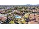 Expansive aerial view highlighting community pool, tile roofs, and mature trees at 5016 E Waltann Ln, Scottsdale, AZ 85254