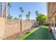 Backyard featuring a block wall, manicured grass and a citrus tree at 5016 E Waltann Ln, Scottsdale, AZ 85254