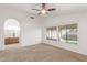 Bright bedroom featuring a ceiling fan, carpeted floor, and ensuite bathroom at 5016 E Waltann Ln, Scottsdale, AZ 85254