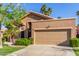 Tan single story home with lush landscaping and a two car garage at 5016 E Waltann Ln, Scottsdale, AZ 85254