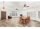 Open-concept living and dining area with tile floors and multiple ceiling fans at 5016 E Waltann Ln, Scottsdale, AZ 85254