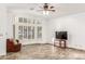 Bright living room with large windows, plantation shutters, and tile flooring at 5016 E Waltann Ln, Scottsdale, AZ 85254