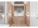 Walk-in shower with decorative glass and tan tiling at 5016 E Waltann Ln, Scottsdale, AZ 85254