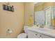Well-lit bathroom featuring a modern vanity with a sink and mirror, complemented by neutral-toned walls and fixtures at 5206 N 16Th Dr, Phoenix, AZ 85015
