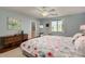 Bright bedroom featuring light blue walls, floral bedding, and a ceiling fan at 5206 N 16Th Dr, Phoenix, AZ 85015