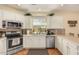 Well-lit kitchen featuring stainless steel appliances and white cabinetry at 5206 N 16Th Dr, Phoenix, AZ 85015