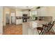 Modern kitchen featuring tiled floors, quartz countertops, stainless steel appliances, and eat-in breakfast bar at 5206 N 16Th Dr, Phoenix, AZ 85015