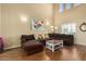 Spacious living room features a large sectional sofa, high ceilings, and wood flooring at 5206 N 16Th Dr, Phoenix, AZ 85015