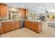 Open kitchen with stainless steel appliances, granite countertops, and a seamless flow into the adjacent living space at 5340 W Turquoise Ave, Glendale, AZ 85302