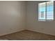 Cozy bedroom featuring plush carpeting, neutral walls, and a window with sunlight at 5519 S 240Th Ln, Buckeye, AZ 85326