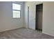 An empty bedroom with carpet and sliding door closet at 5519 S 240Th Ln, Buckeye, AZ 85326