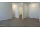 Empty bedroom with ensuite bathroom and wood-style flooring at 5519 S 240Th Ln, Buckeye, AZ 85326