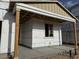 Close up exterior of covered front porch with wooden posts and a window at 5519 S 240Th Ln, Buckeye, AZ 85326
