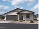 Charming single-story home with a neutral color scheme, two-car garage, and low maintenance landscaping at 5519 S 240Th Ln, Buckeye, AZ 85326