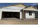 Exterior view of a partially constructed home showing the garage and covered porch at 5519 S 240Th Ln, Buckeye, AZ 85326
