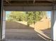 Framed garage view to backyard shows trees and block fence at 5519 S 240Th Ln, Buckeye, AZ 85326