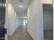 Bright hallway features wood-look flooring and fresh neutral paint leading to the main living area at 5519 S 240Th Ln, Buckeye, AZ 85326