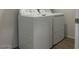 Laundry room with a white washing machine and dryer at 5519 S 240Th Ln, Buckeye, AZ 85326