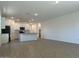 Open concept living room and kitchen area with wood-look floors and lots of natural light at 5519 S 240Th Ln, Buckeye, AZ 85326