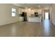 Open concept living room and kitchen area with wood-look floors and lots of natural light at 5519 S 240Th Ln, Buckeye, AZ 85326