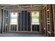New construction living room framed with two windows letting in natural light at 5519 S 240Th Ln, Buckeye, AZ 85326