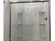 Modern tiled shower with glass door and metal handle at 5519 S 240Th Ln, Buckeye, AZ 85326