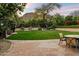Lush backyard featuring mature trees and stone terraces, perfect for outdoor gatherings and relaxing in nature at 6402 E Chaparral Rd, Paradise Valley, AZ 85253