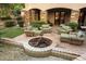 Charming backyard patio featuring comfortable seating around a stone fire pit, ideal for entertaining guests at 6402 E Chaparral Rd, Paradise Valley, AZ 85253