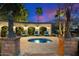 Relaxing backyard spa area with elegant seating and statues, creating a peaceful outdoor retreat for rejuvenation at 6402 E Chaparral Rd, Paradise Valley, AZ 85253