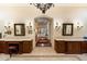 Lavish bathroom featuring dual vanities with granite countertops, ornate mirrors, and elegant lighting fixtures at 6402 E Chaparral Rd, Paradise Valley, AZ 85253