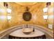 Unique bathroom featuring a stone sink basin, decorative mirror, sconce lighting and artistic walls at 6402 E Chaparral Rd, Paradise Valley, AZ 85253