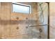 Modern bathroom features tiled shower with glass door and tiled walls at 6402 E Chaparral Rd, Paradise Valley, AZ 85253