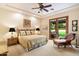Inviting bedroom with a queen-sized bed, ceiling fan, and sliding glass doors leading to the outside at 6402 E Chaparral Rd, Paradise Valley, AZ 85253