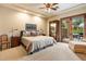 Spacious bedroom with a king-size bed, wooden furniture, and sliding doors to a private patio at 6402 E Chaparral Rd, Paradise Valley, AZ 85253
