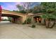 Inviting driveway leads to the home with lush landscaping, creating a welcoming entrance and enhancing curb appeal at 6402 E Chaparral Rd, Paradise Valley, AZ 85253