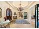 Elegant foyer with chandelier, marble floors, wooden doors and sophisticated decor at 6402 E Chaparral Rd, Paradise Valley, AZ 85253