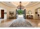 Grand foyer featuring a soaring ceiling, chandelier, iron doors and luxury finishes at 6402 E Chaparral Rd, Paradise Valley, AZ 85253