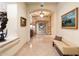 Hallway with arched doorways, travertine floors, and decorative paintings leading to various rooms at 6402 E Chaparral Rd, Paradise Valley, AZ 85253