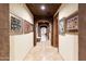 Inviting hallway with stone floors, brick arches, and decorative Gathering photos displayed on the walls at 6402 E Chaparral Rd, Paradise Valley, AZ 85253