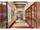 Elegant hallway with hardwood floors, custom built-in cabinetry, and abundant natural light streaming through the windows at 6402 E Chaparral Rd, Paradise Valley, AZ 85253